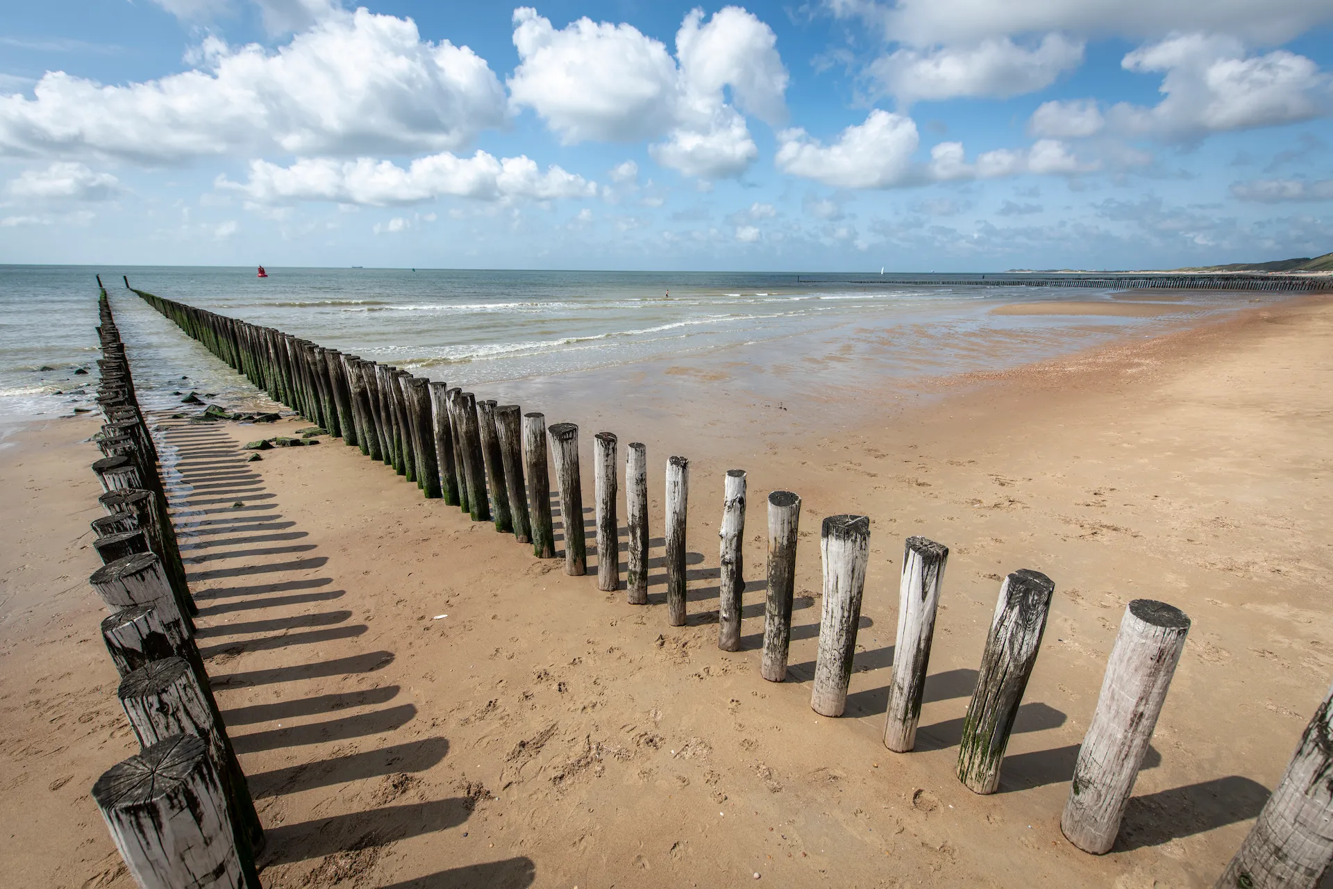 Zeeland beach with blue skies and a few clouds during the day in the summer