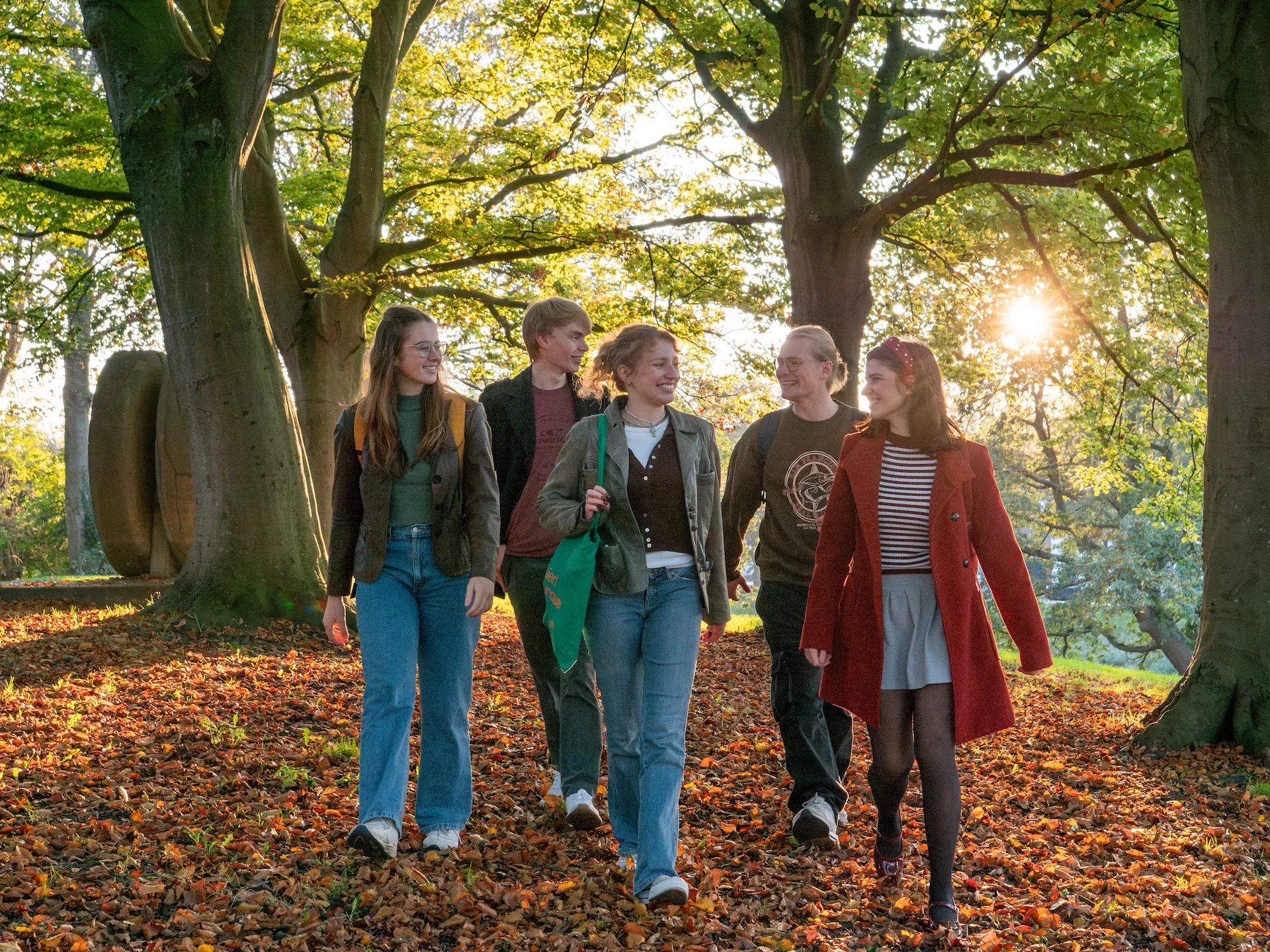 Students walking in a park in autumn