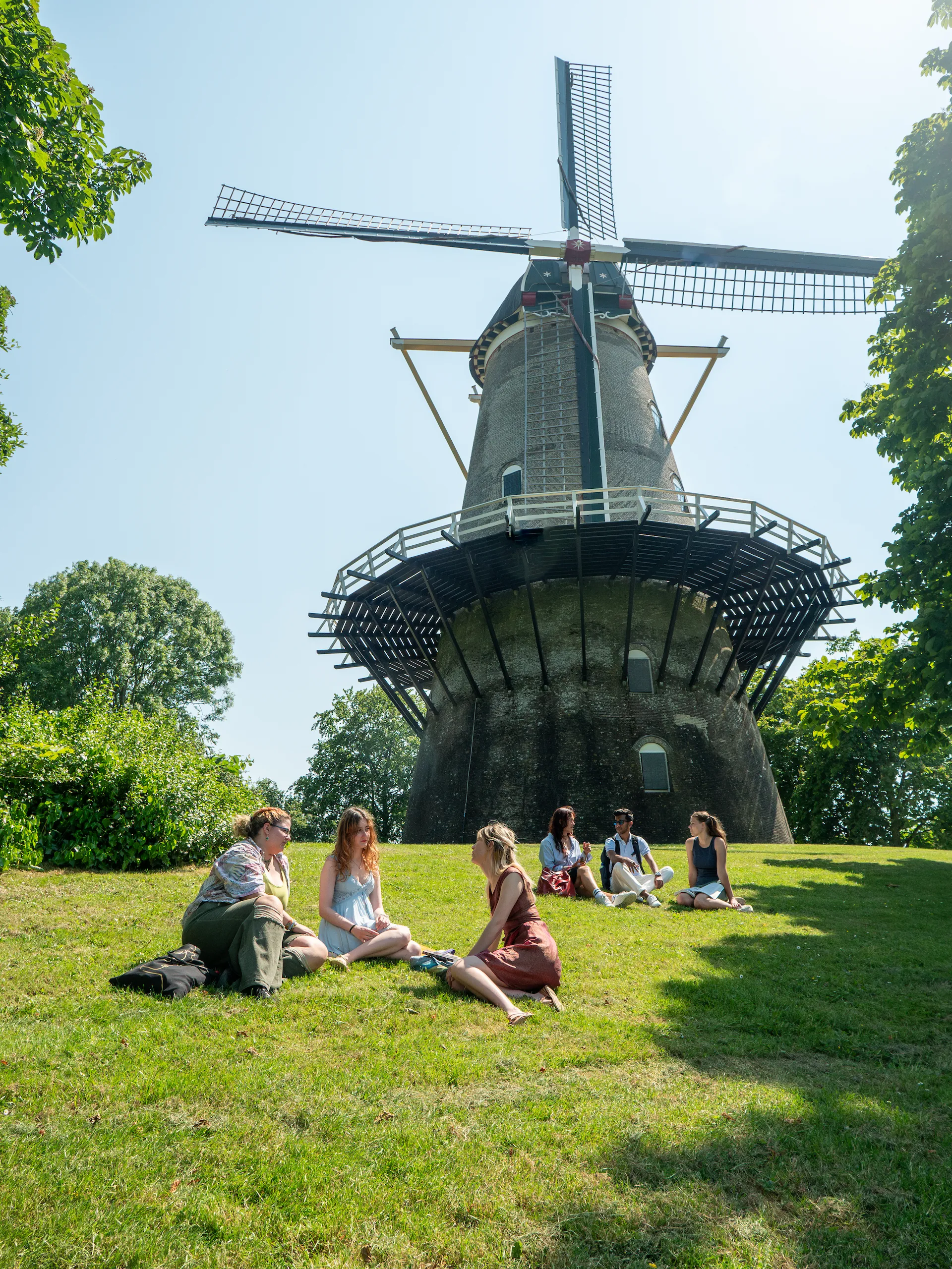 College students sitting infront of a windmill in middelburg